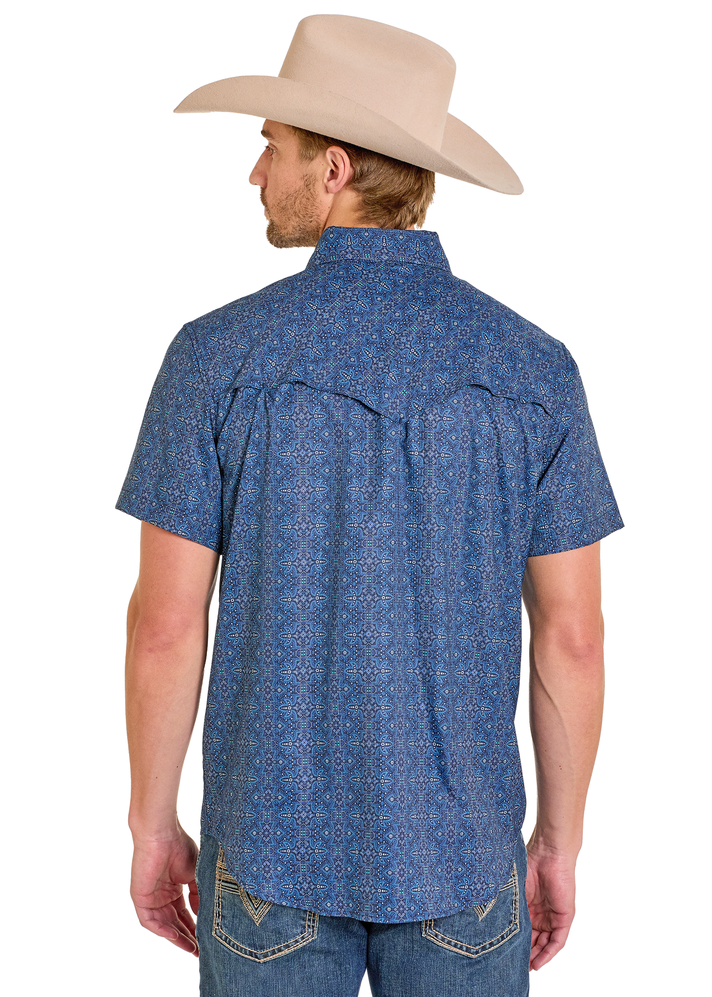 Man wearing a blue patterned short-sleeve shirt and beige cowboy hat on a white background