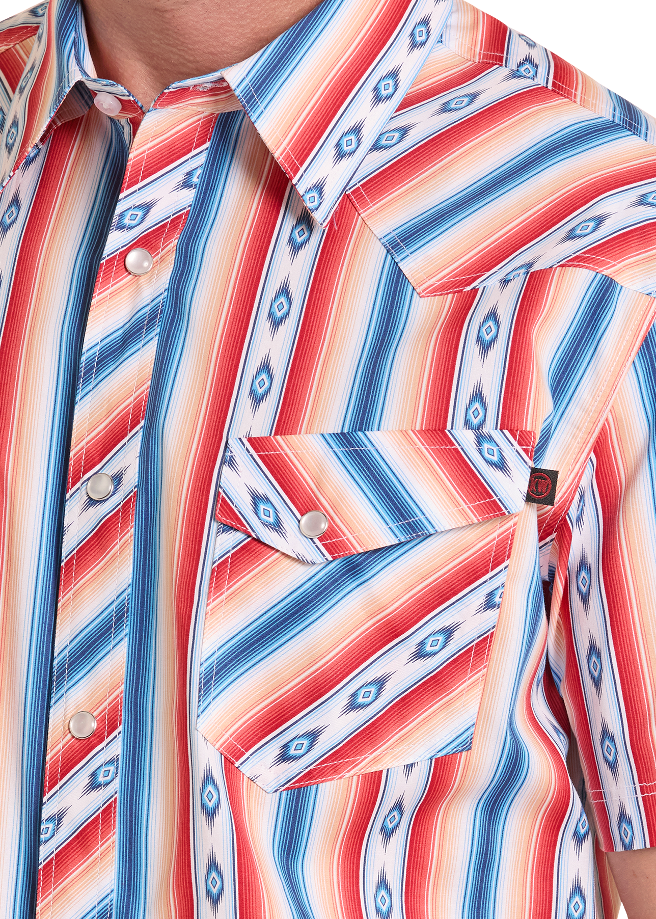Close-up of a colorful patterned shirt with red, blue, and white stripes.