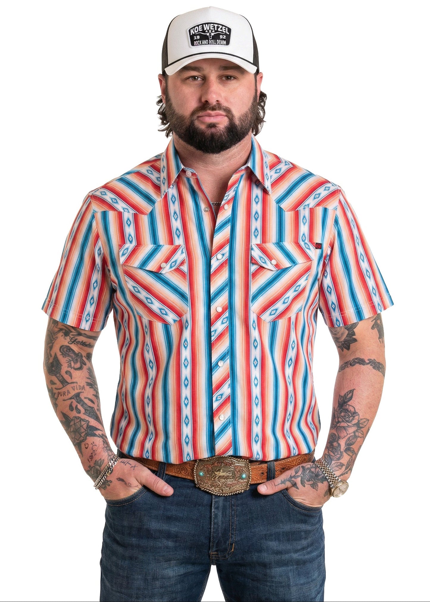 Koe Wetzel wearing a colorful striped shirt and cap on a white background