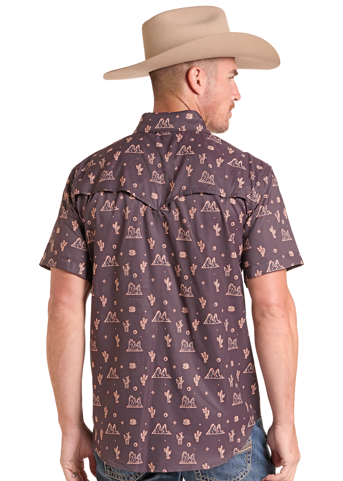 A man wearing a brown short-sleeve western shirt with a beige cactus and mountain pattern, paired with a tan cowboy hat, shown from the back against a white background.