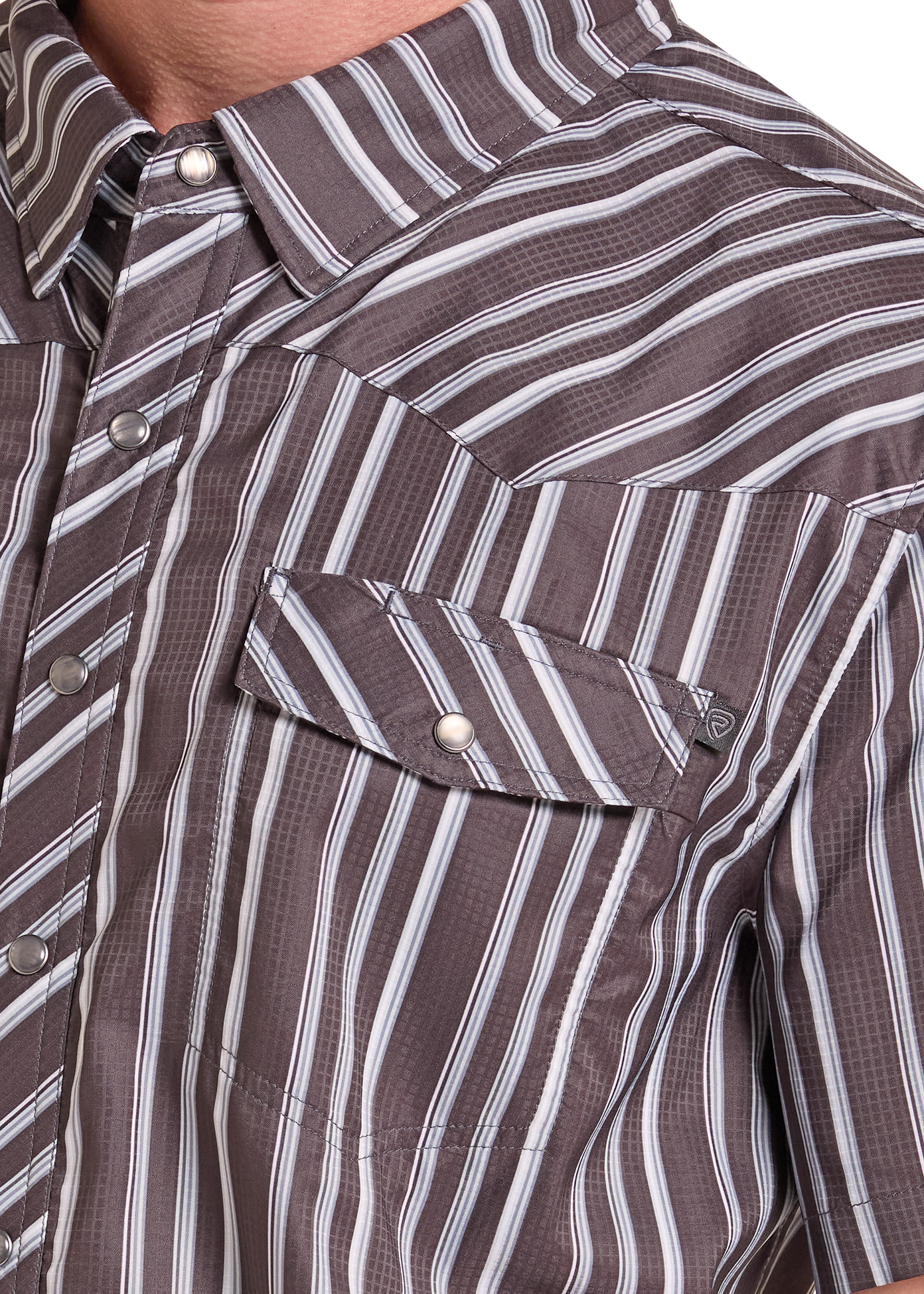 Close-up of a man wearing a short-sleeve western-style button-up shirt with vertical brown, gray, and white stripes and a chest pocket.