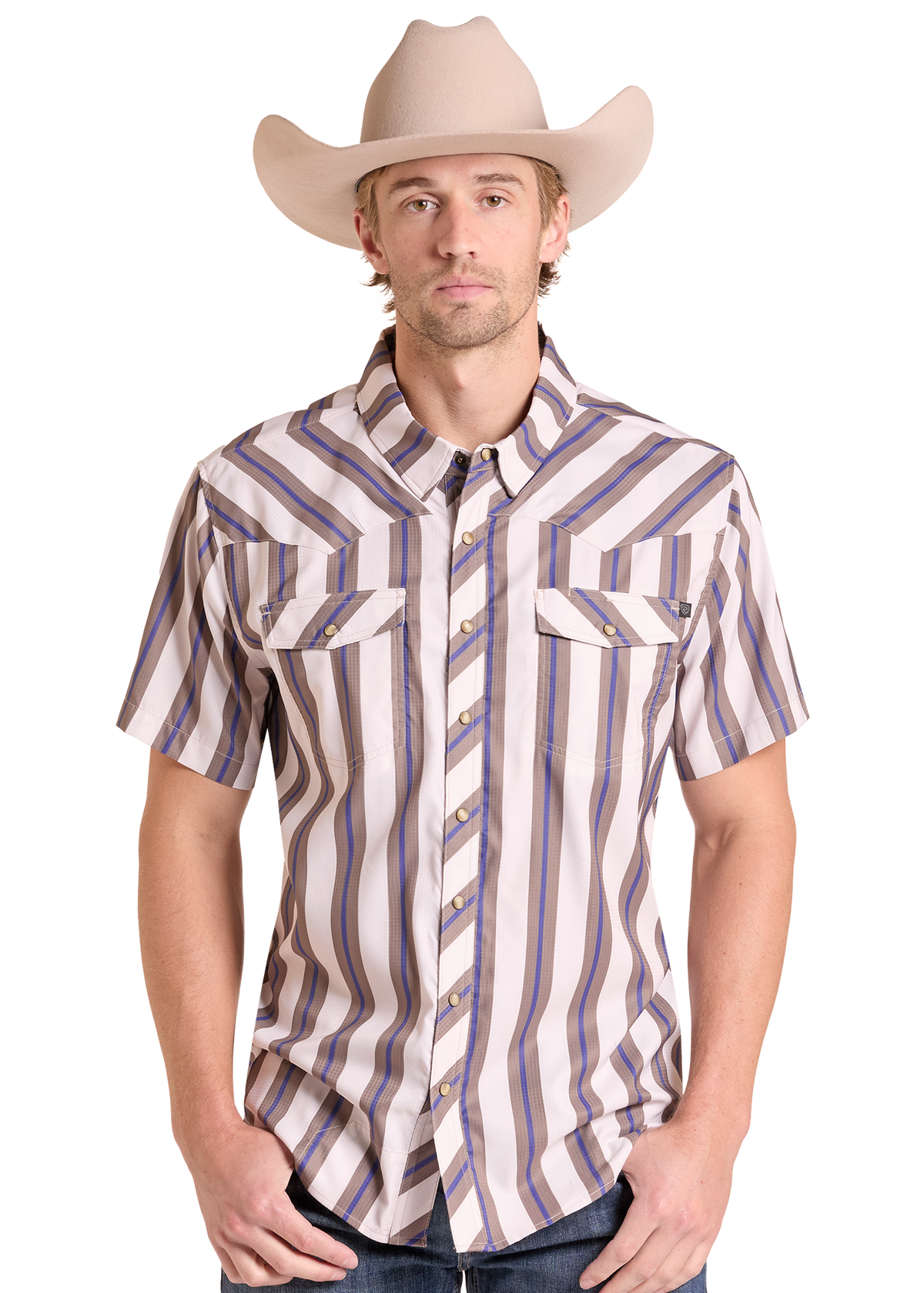 A man wearing a beige cowboy hat and a short-sleeve western button-up shirt with vertical stripes in beige, brown, and blue, paired with dark jeans against a white background.