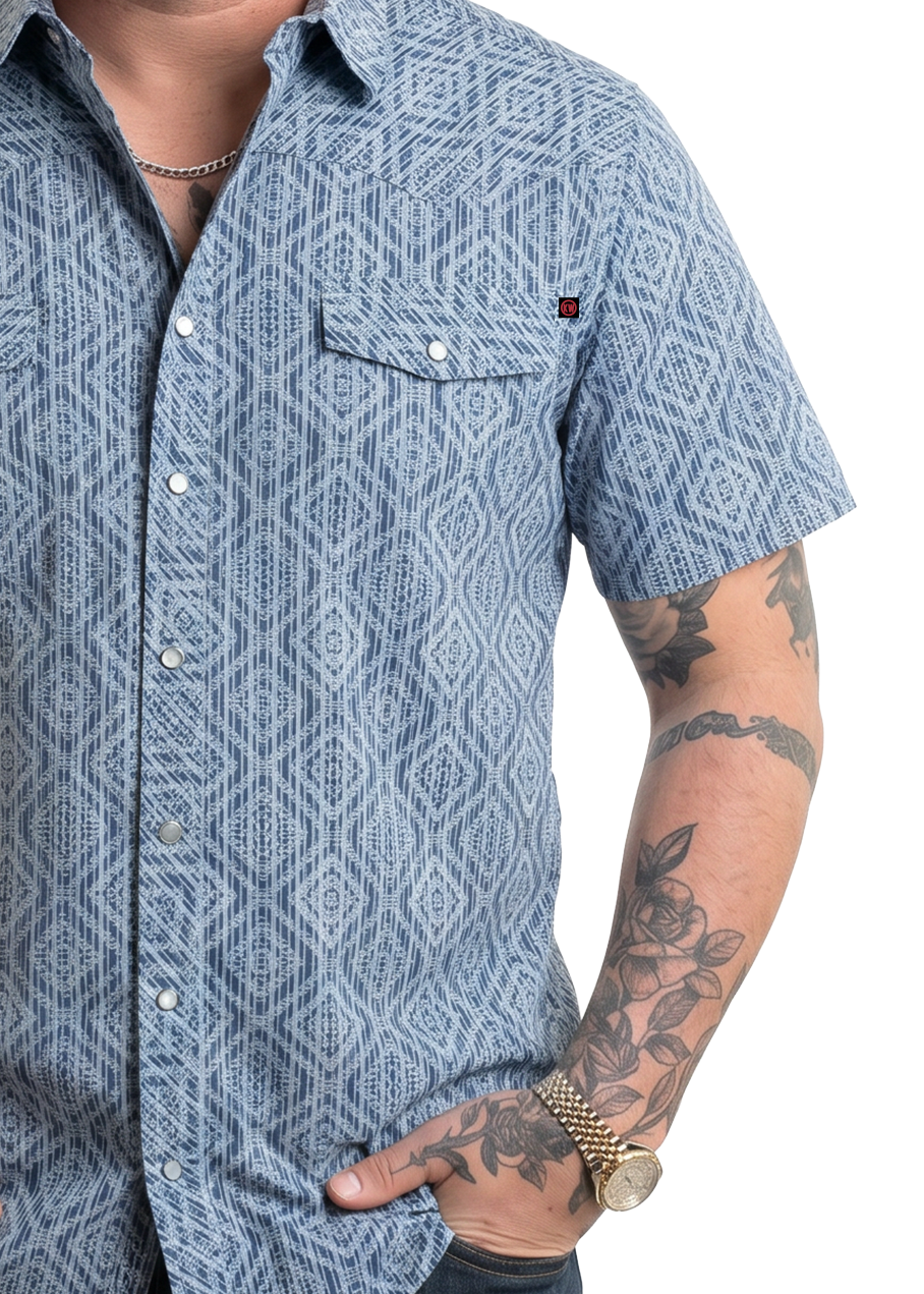 Koe Wetzel wearing a blue patterned shirt with tattoos on his arms, on a white background