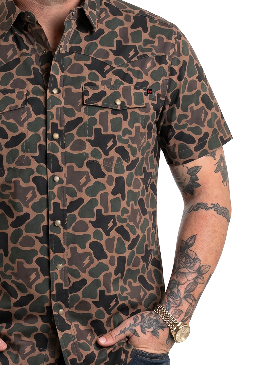 Koe Wetzel wearing a camouflage shirt and cap on a white background