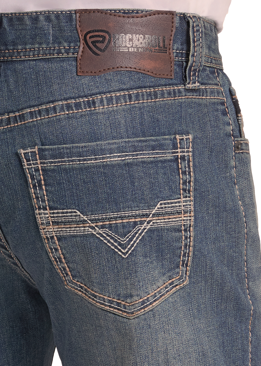 Close-up of the back waistband and rear pocket of blue denim jeans with contrast stitching and a brown RockRoll brand patch.