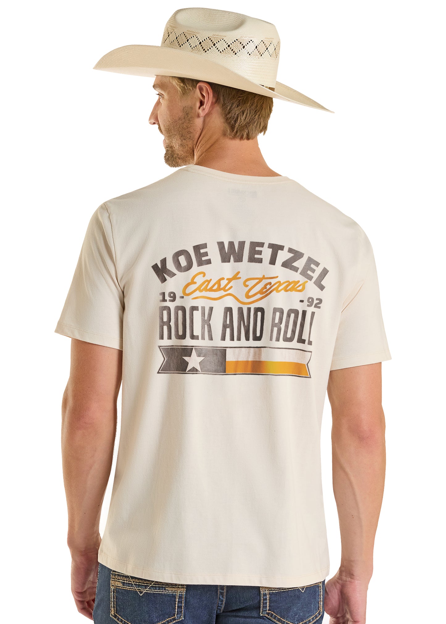 Man wearing a t-shirt with 'Koe Wetzel East Texas Rock and Roll' text, standing against a white background.