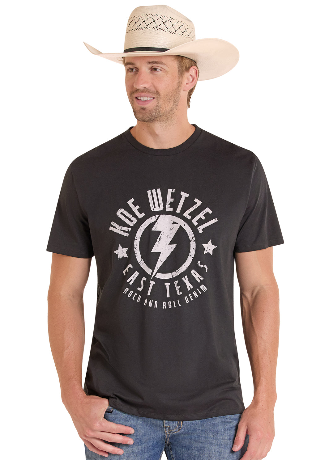 Man wearing a black Koe Wetzel t-shirt with a logo and text, standing against a white background