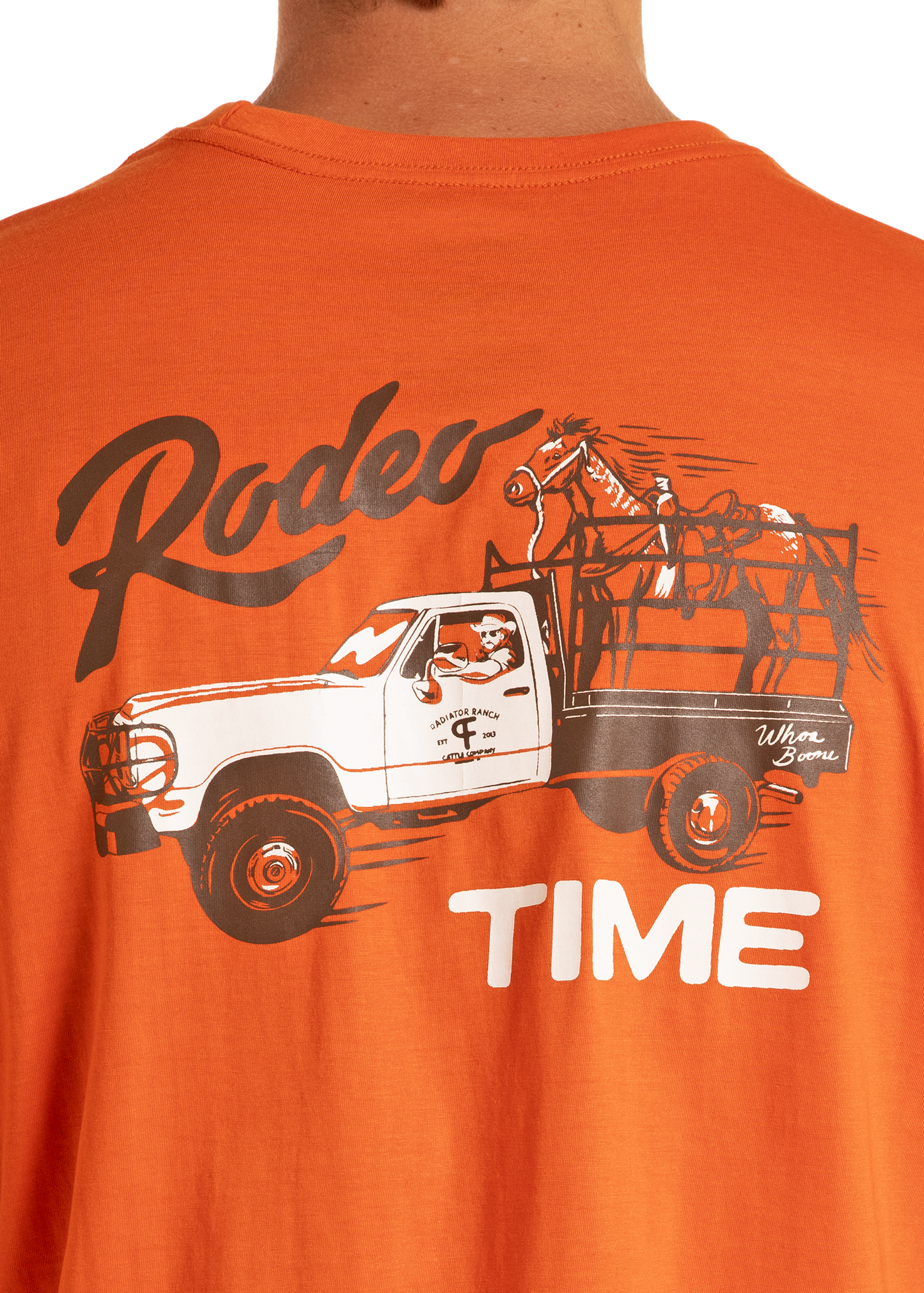 Orange t-shirt with a graphic of a truck and horse, and the text 'Rodeo Time'.
