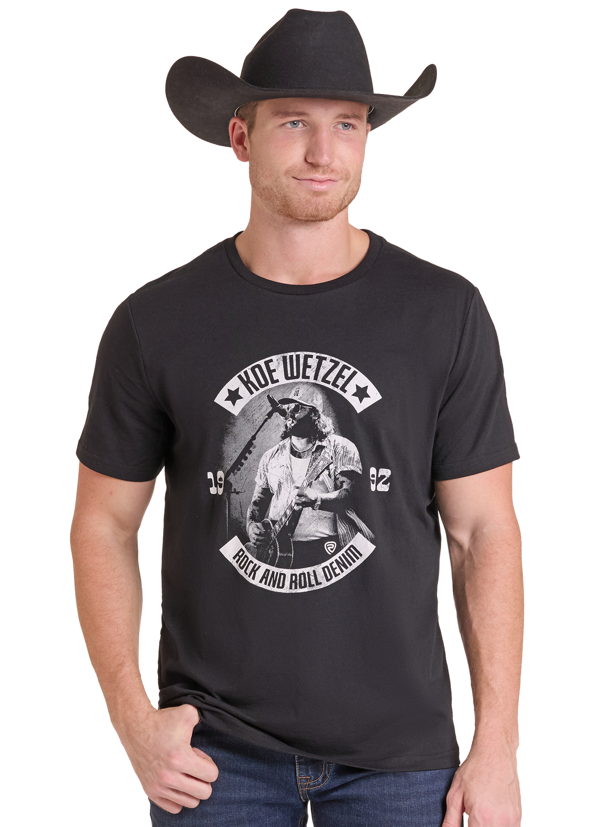 A man wearing a black cowboy hat and a black graphic t-shirt with a white print that reads 'HOF WETZEL ROCK AND ROLL DENIAL'.