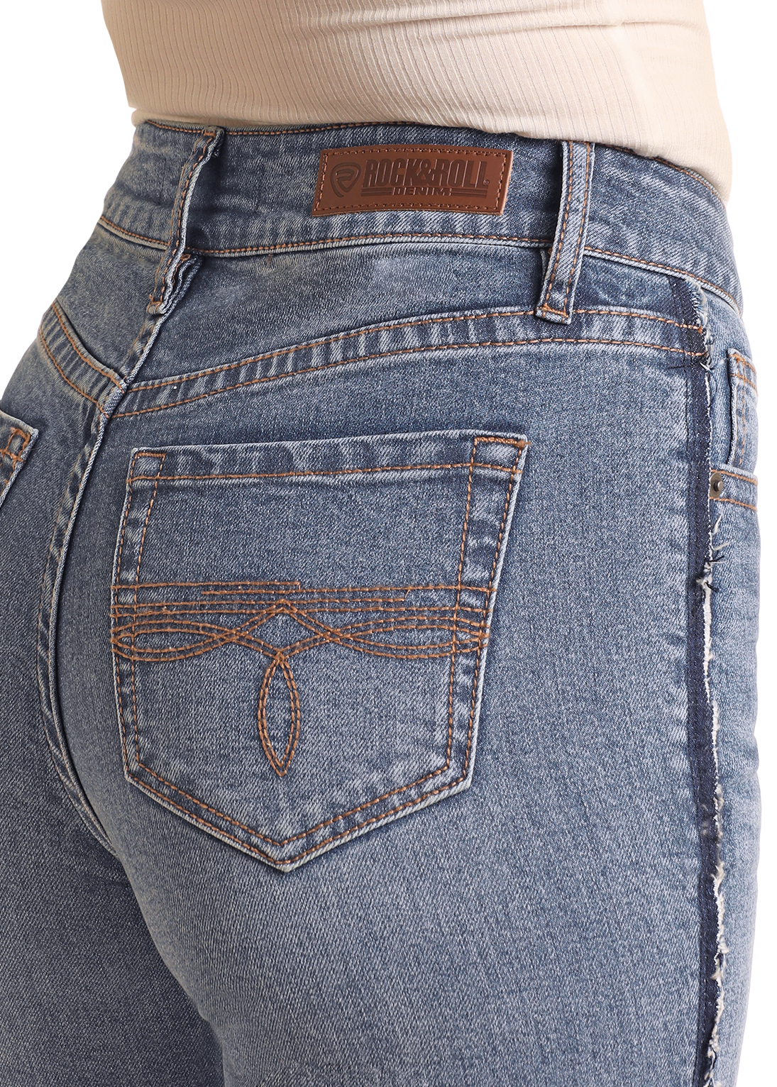 Close-up of blue jeans with a brand label on a white background