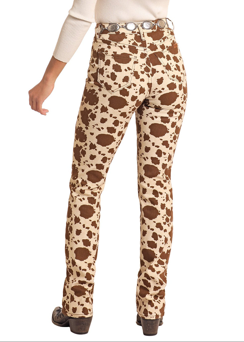 Woman wearing leopard print pants and a brown hat on a white background