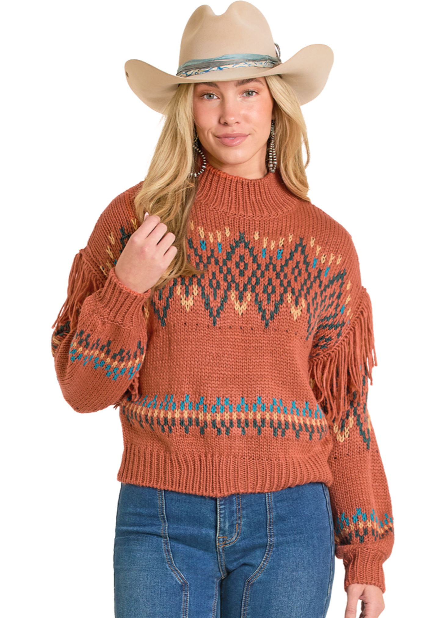 Woman wearing a brown fringed sweater and blue jeans on a white background