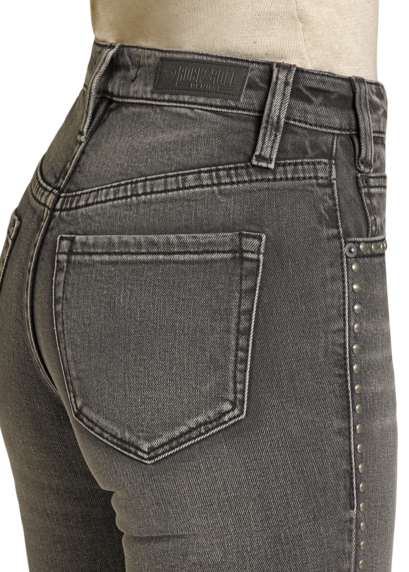 Gray jeans with studded details on a white background