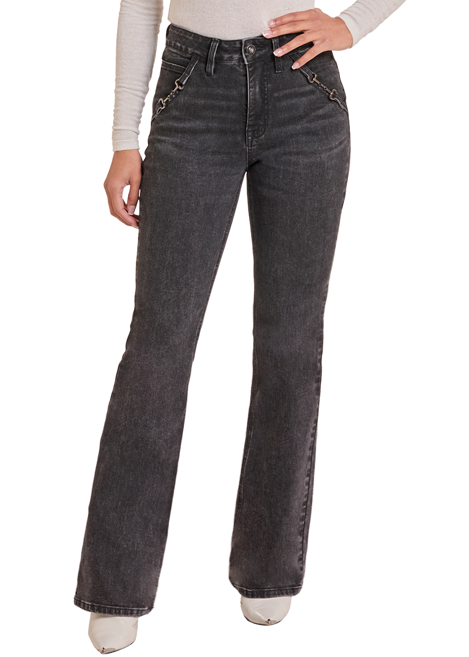 Woman in black jeans with metal horse bit details on the pockets.