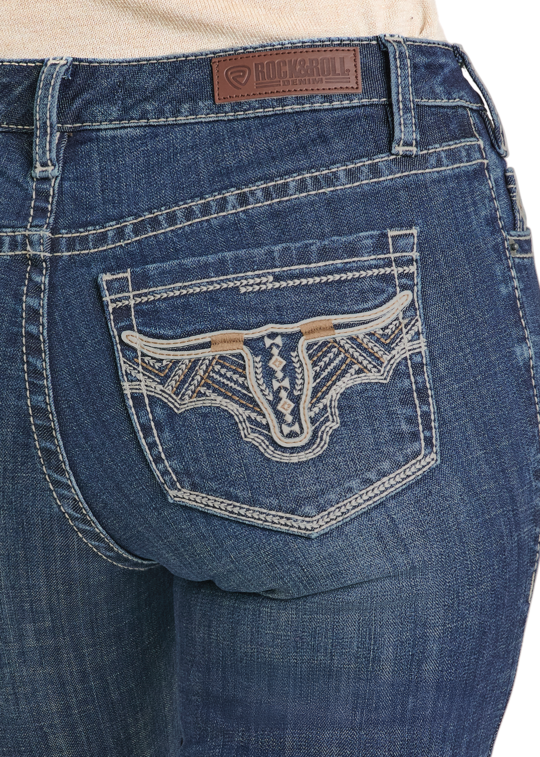 Close-up of blue jeans with a decorative back pocket and brand logo.