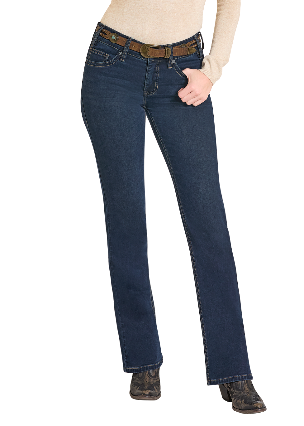 A person wearing Rock & Roll Denim Mid Rise Boot Stitch Steer Head Bootcut Jeans, a brown belt, beige long-sleeve shirt, and black boots stands against a white background with one hand in a front pocket.