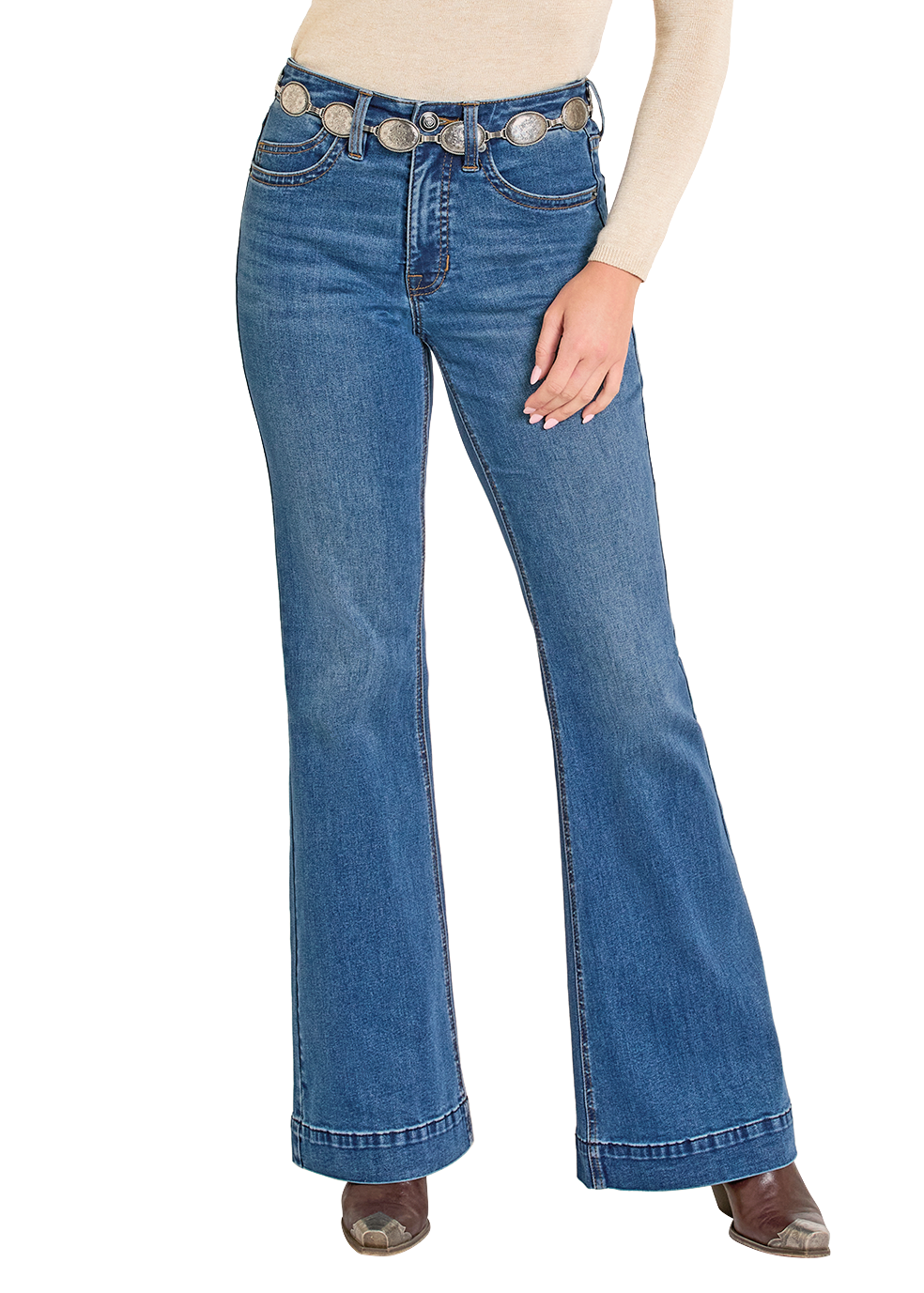 Woman wearing a beige top, blue jeans, and a brown cowboy hat on a white background