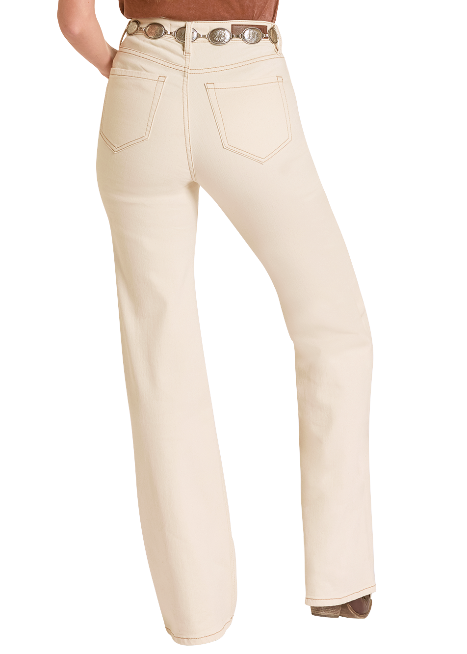 Woman wearing a brown top and cream pants on a white background
