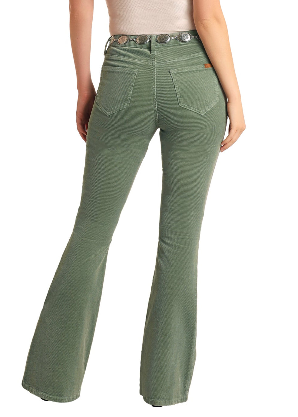 Woman wearing green bell-bottom pants and a white top with a brown cowboy hat on a white background