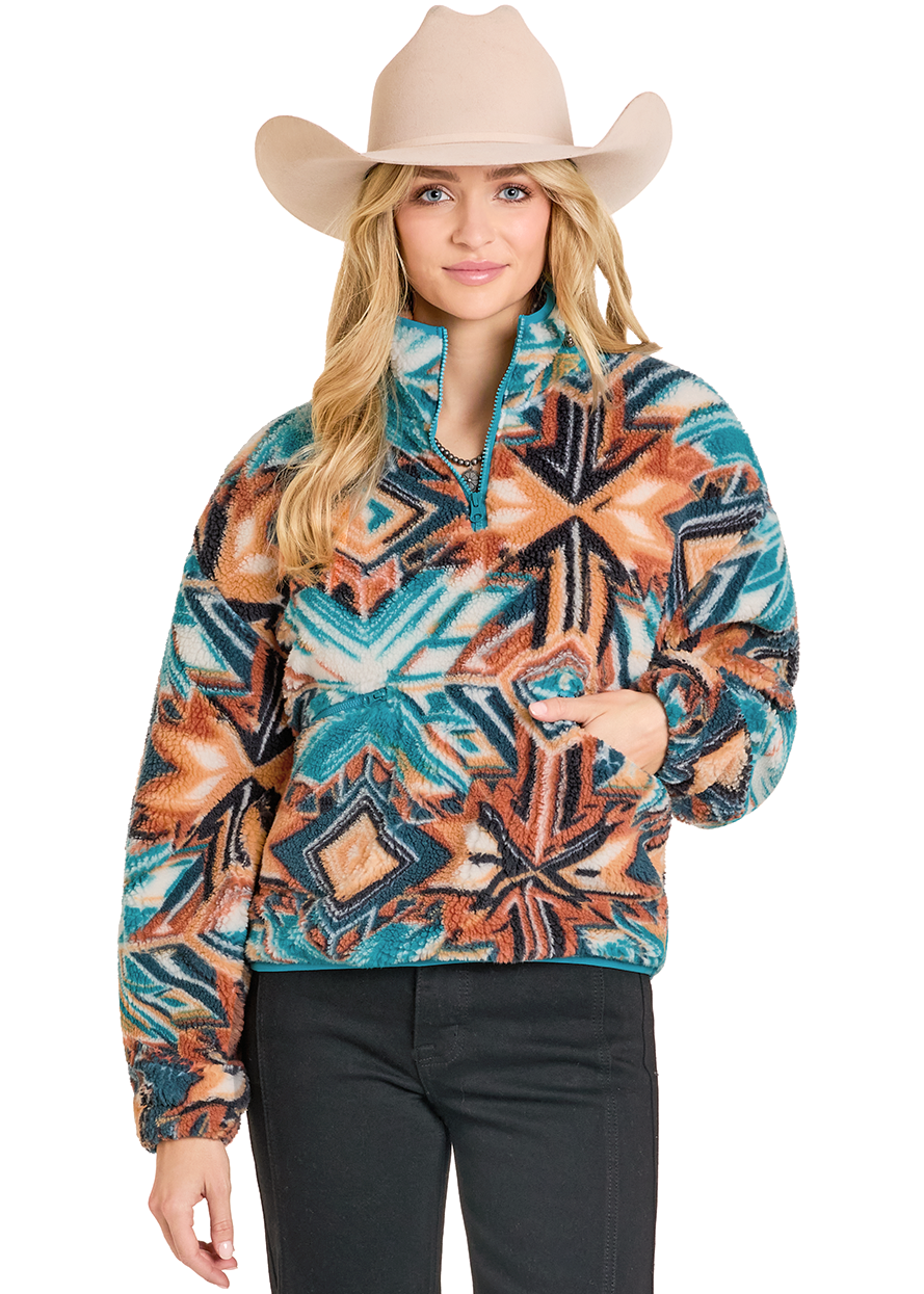 Woman wearing a patterned pullover and cowboy hat on a white background