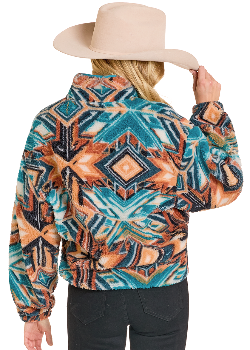 Person wearing a colorful patterned jacket with a beige hat on a white background