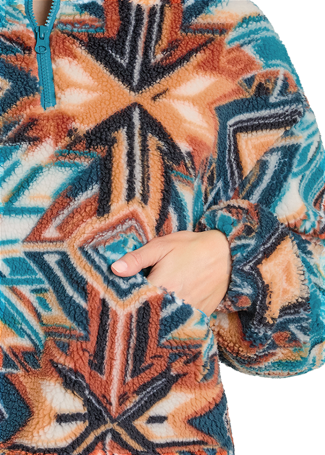 Close-up of a patterned fabric with geometric design in orange, blue, and beige.