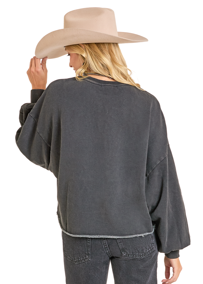 Person wearing a gray outfit with a wide-brimmed hat on a white background