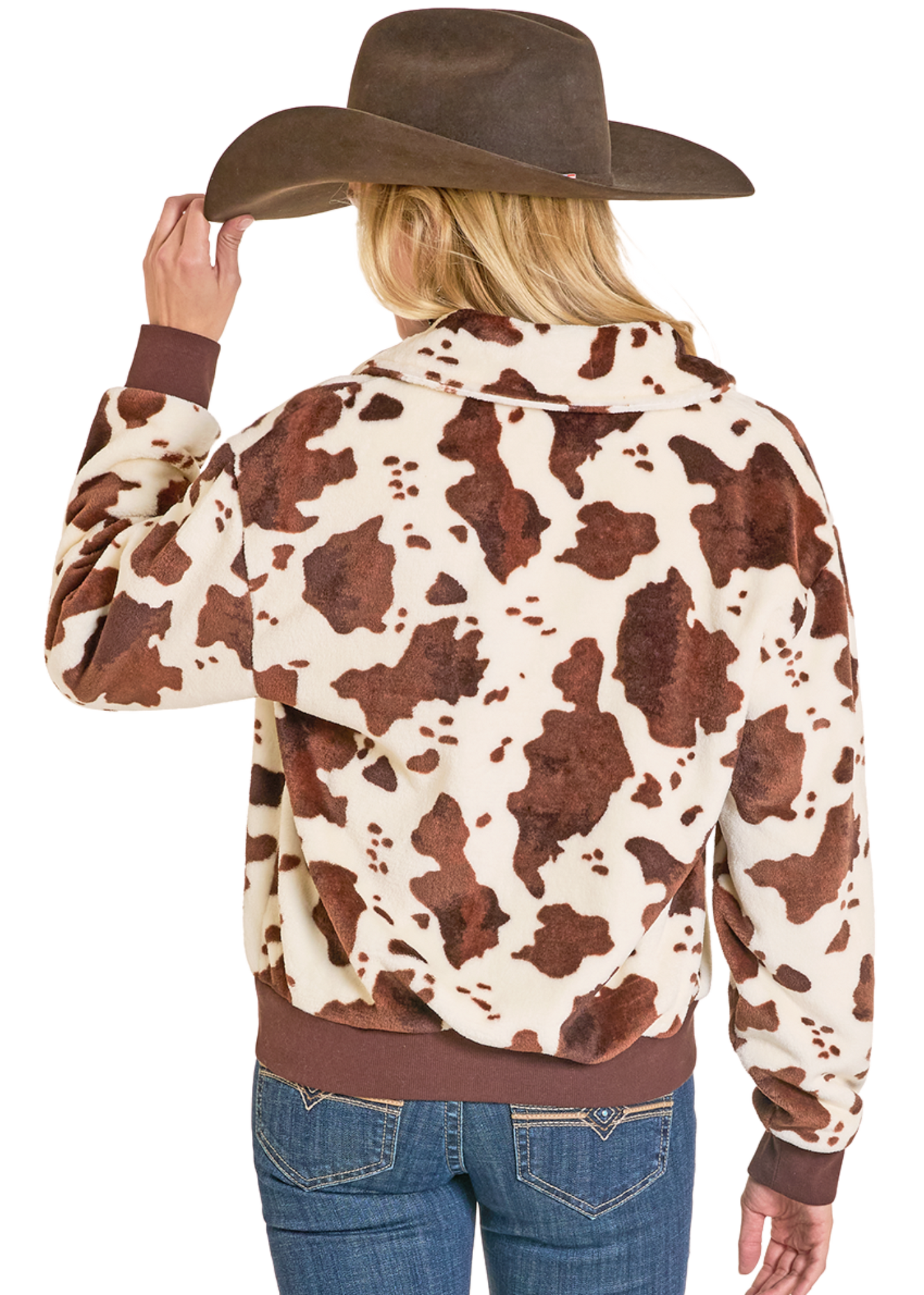 Person wearing a cow print jacket and cowboy hat on a white background