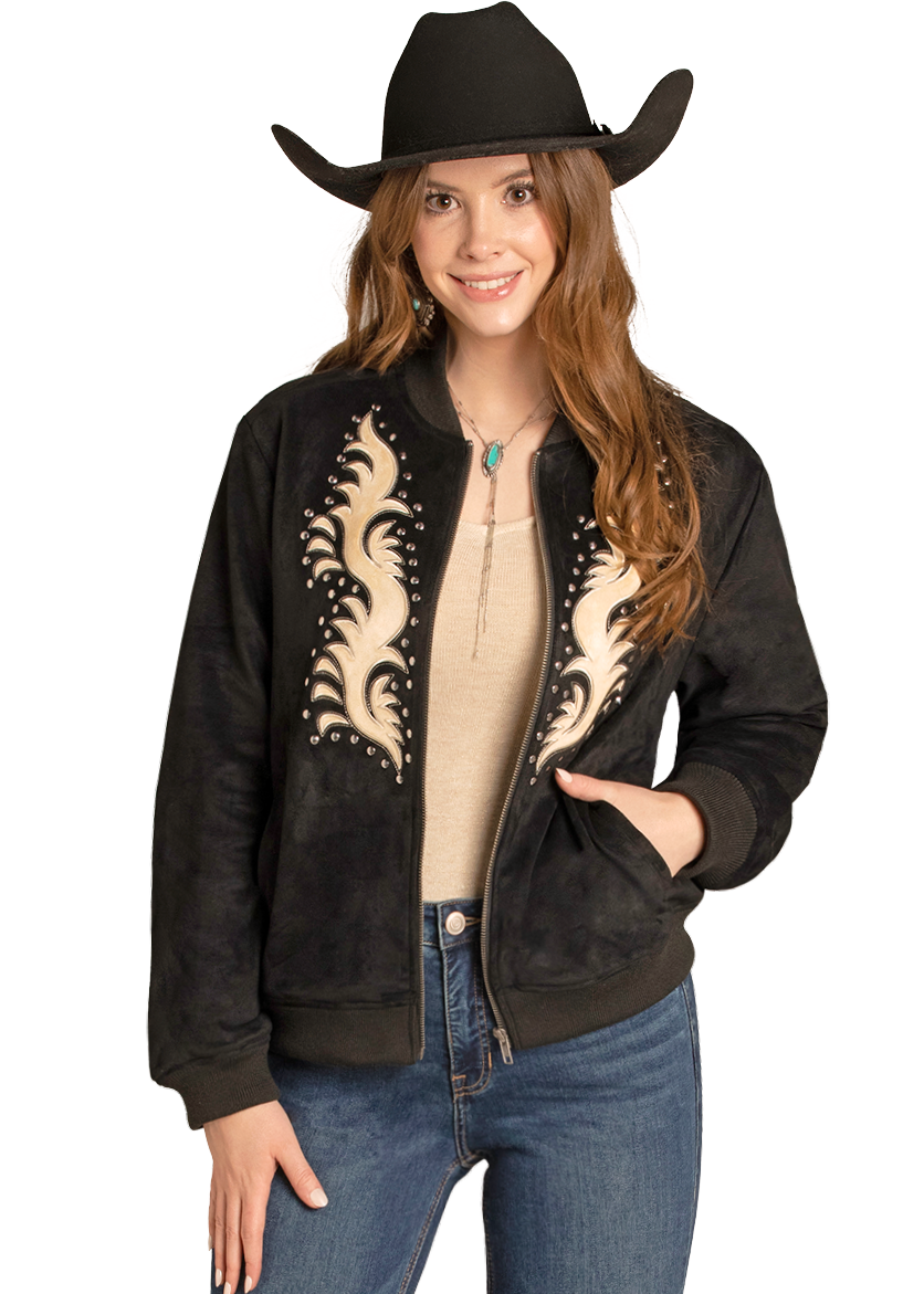 A woman smiles with one hand in her pocket, wearing the Rock & Roll Denim Microsuede Studded Applique Bomber Jacket, a black cowboy hat, beige top, blue jeans, and a turquoise necklace.