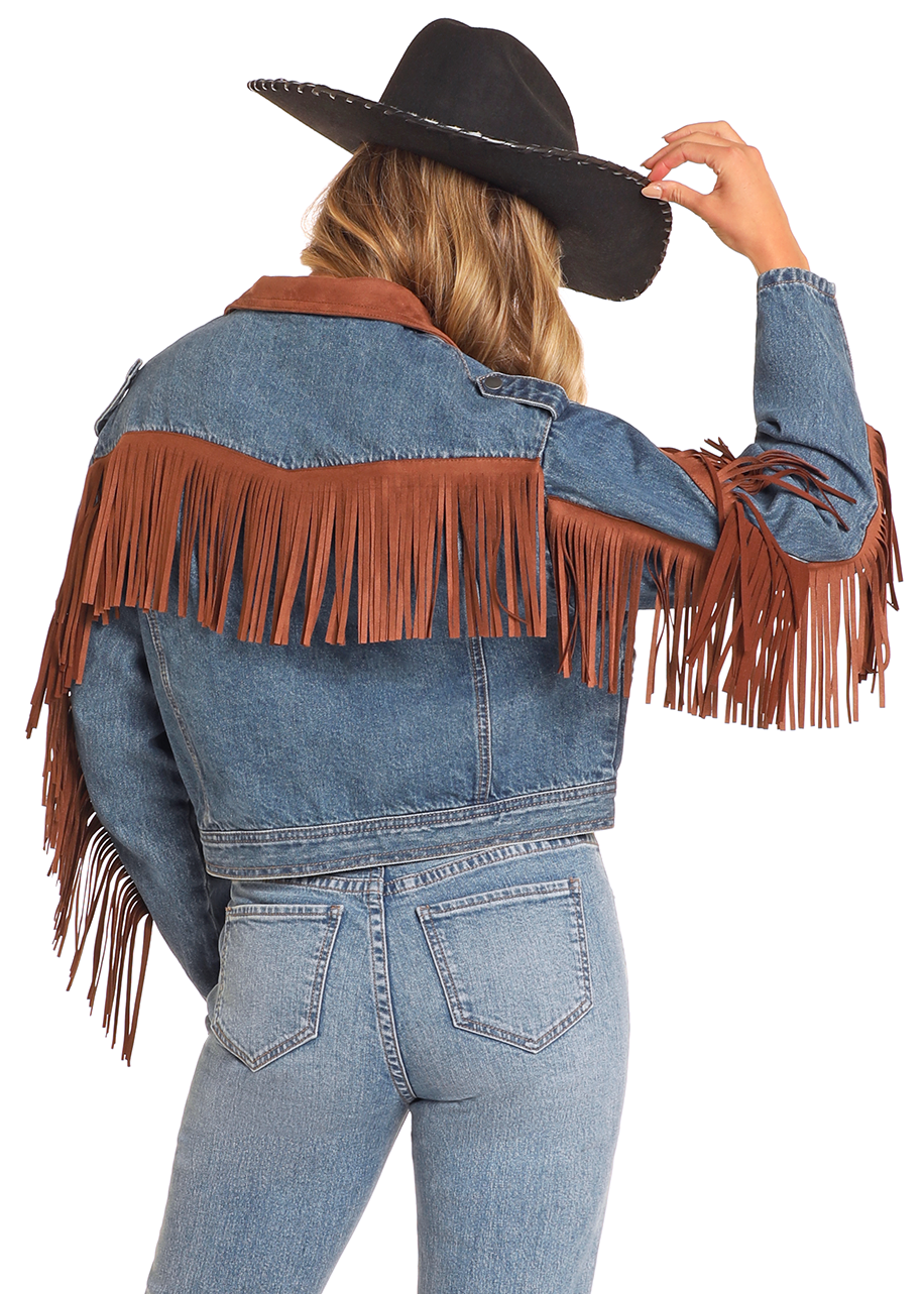 Person wearing a denim jacket with brown fringes and a cowboy hat on a white background