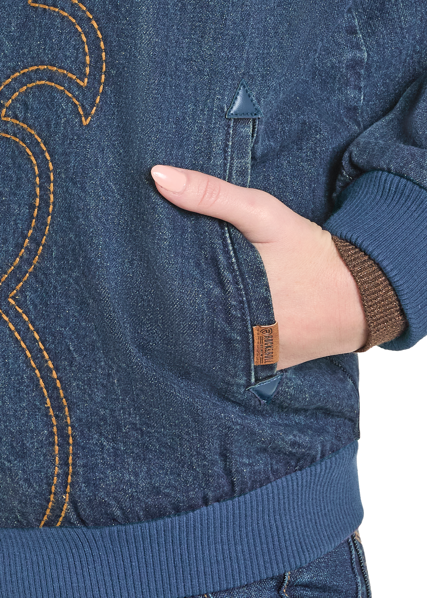 Close-up of a person wearing a blue denim jacket with a hand in the pocket on a white background