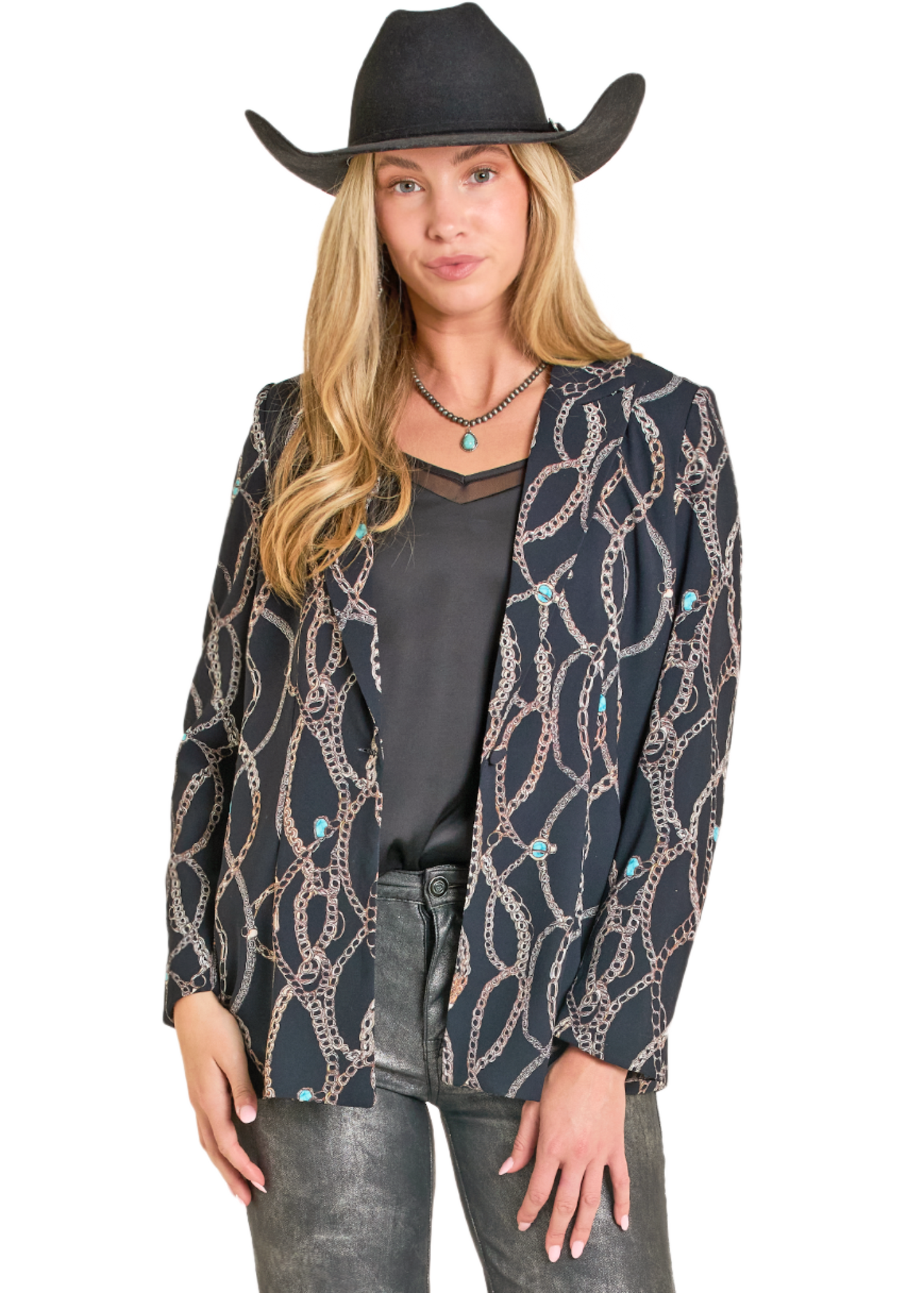 Woman wearing a patterned cardigan, black shirt, and cowboy hat on a white background