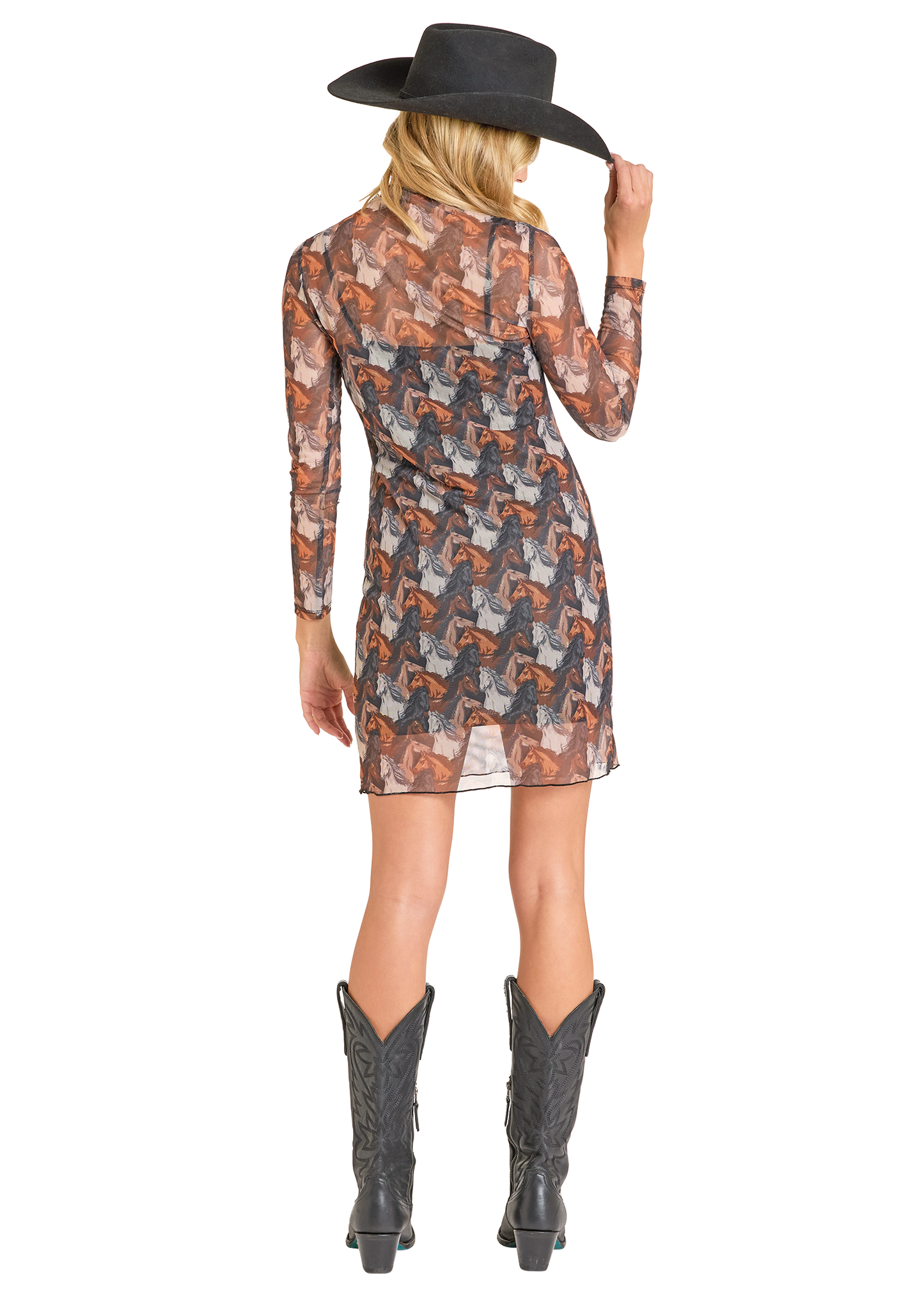 Woman wearing a patterned dress, black cowboy hat, and black cowboy boots on a white background