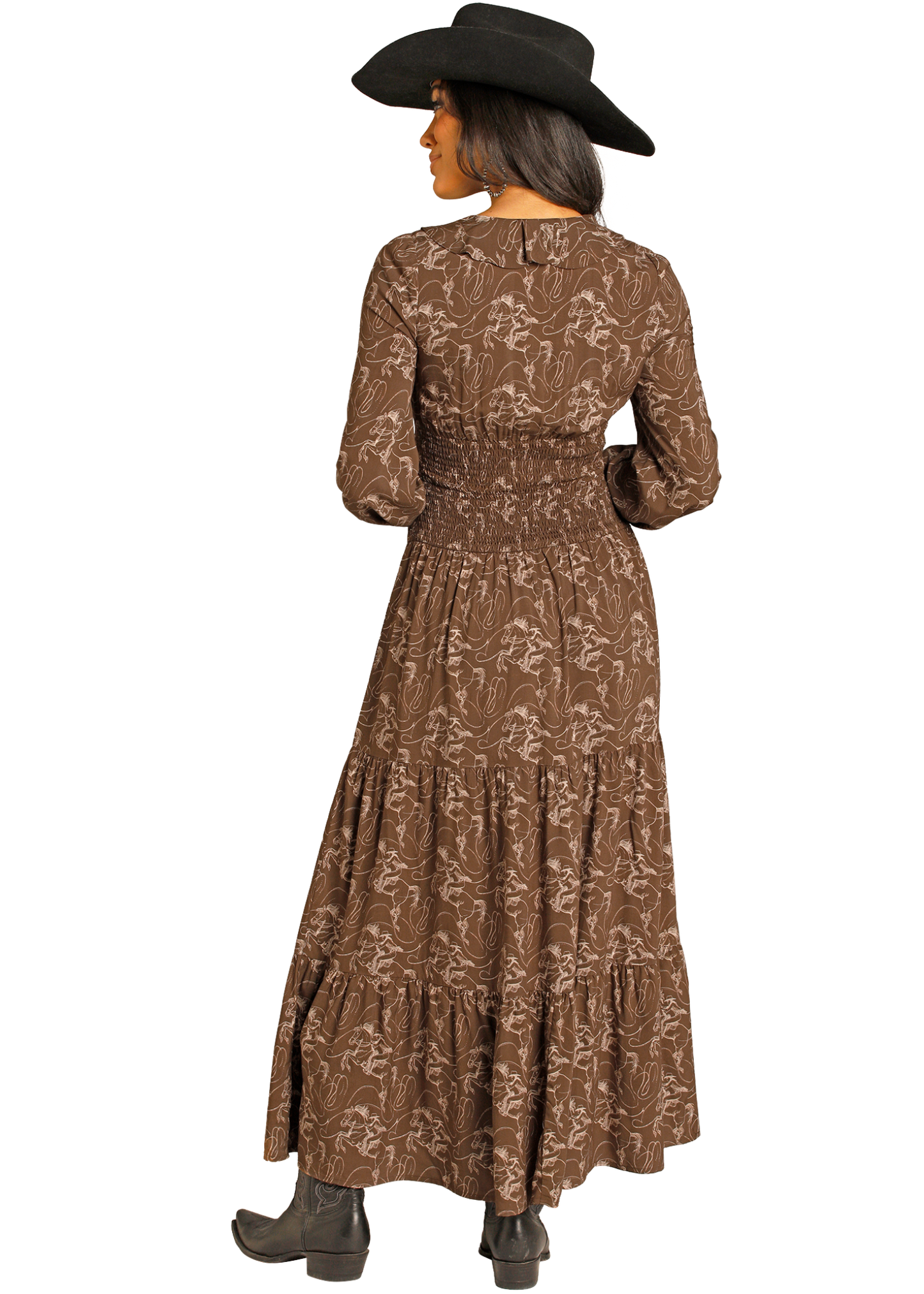 Woman wearing a long brown floral dress with a black cowboy hat on a white background