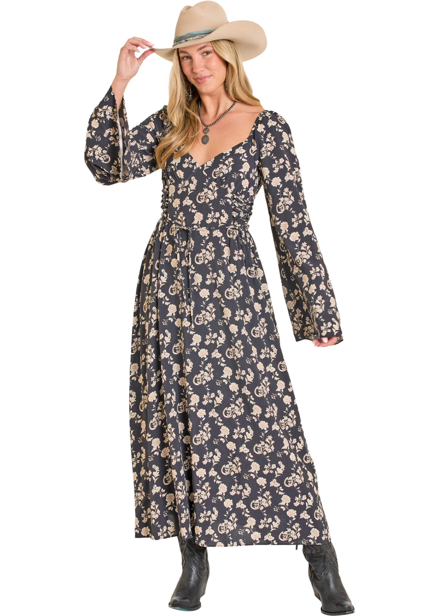 Woman wearing a long floral dress and cowboy hat on a white background