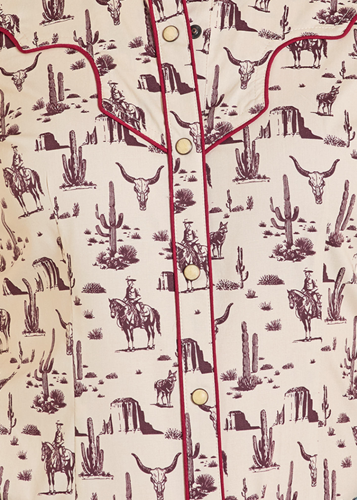Patterned shirt with desert-themed design featuring cacti, horses, and cowboys on a beige background.