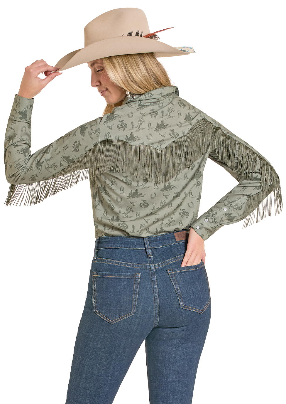 Woman wearing a patterned long-sleeve top with fringe and blue jeans on a white background