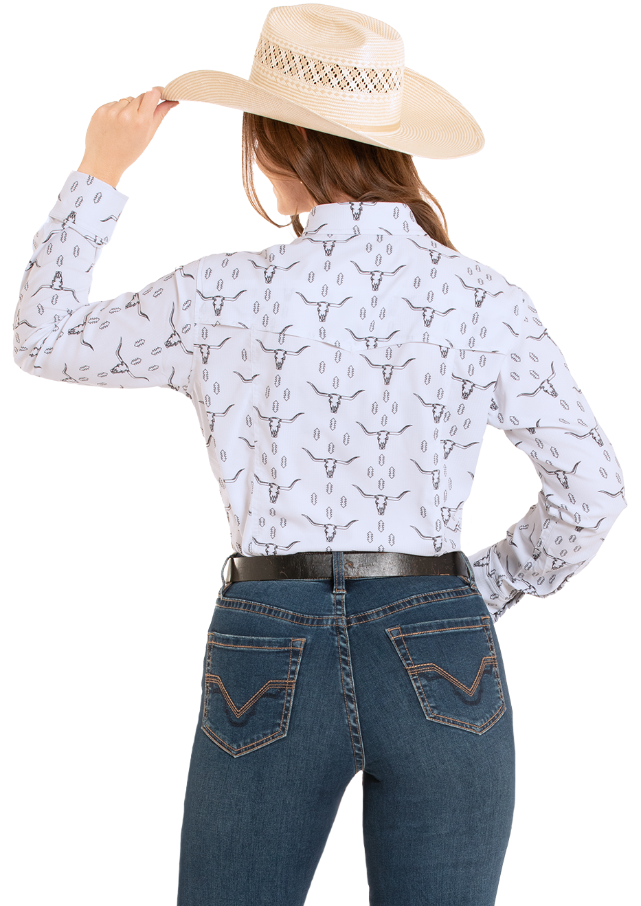 Person wearing a white long-sleeve shirt with black patterns and blue jeans, holding a beige cowboy hat.