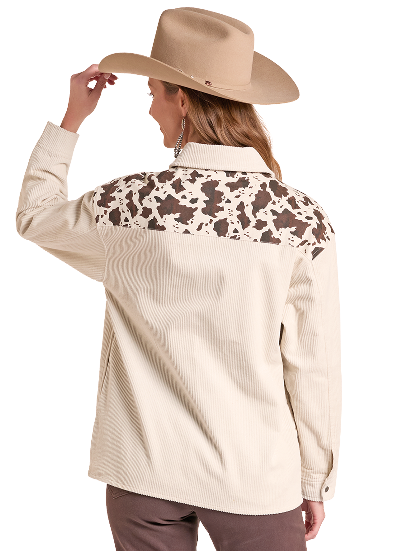 A woman shown from the back wearing a beige western-style shirt jacket with a brown and beige cow-print yoke across the shoulders.