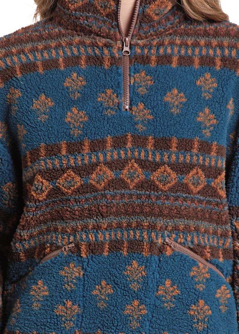 Close-up of a fleece quarter-zip pullover sweater with a blue, brown, and rust-orange geometric pattern.