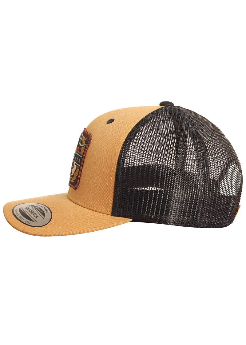 The Dale Brisby Radiator Ranch Skull Cap by Rock & Roll Denim is a tan and black trucker hat with a flat brim, mesh back, snapback closure, and a colorful front patch, shown from the side.