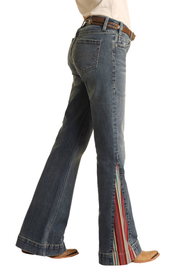 Woman wearing a white shirt, blue jeans, and a cowboy hat on a white background