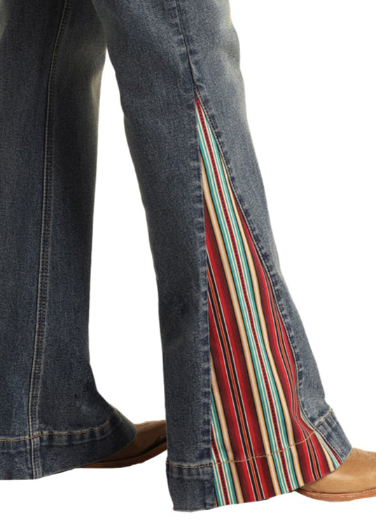 Blue jeans with colorful striped side panels on a white background