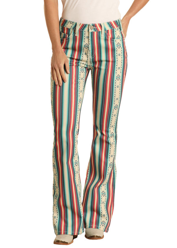 Woman wearing a white t-shirt and colorful striped pants with a straw hat on a white background