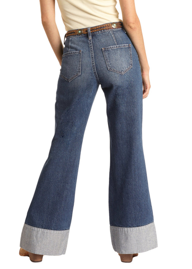 Flared jeans worn by a person on a white background
