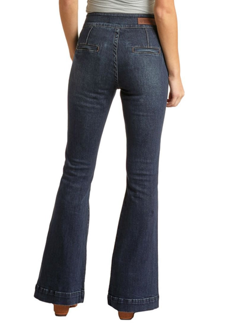 Woman wearing a gray tank top and blue jeans with a cowboy hat on a white background