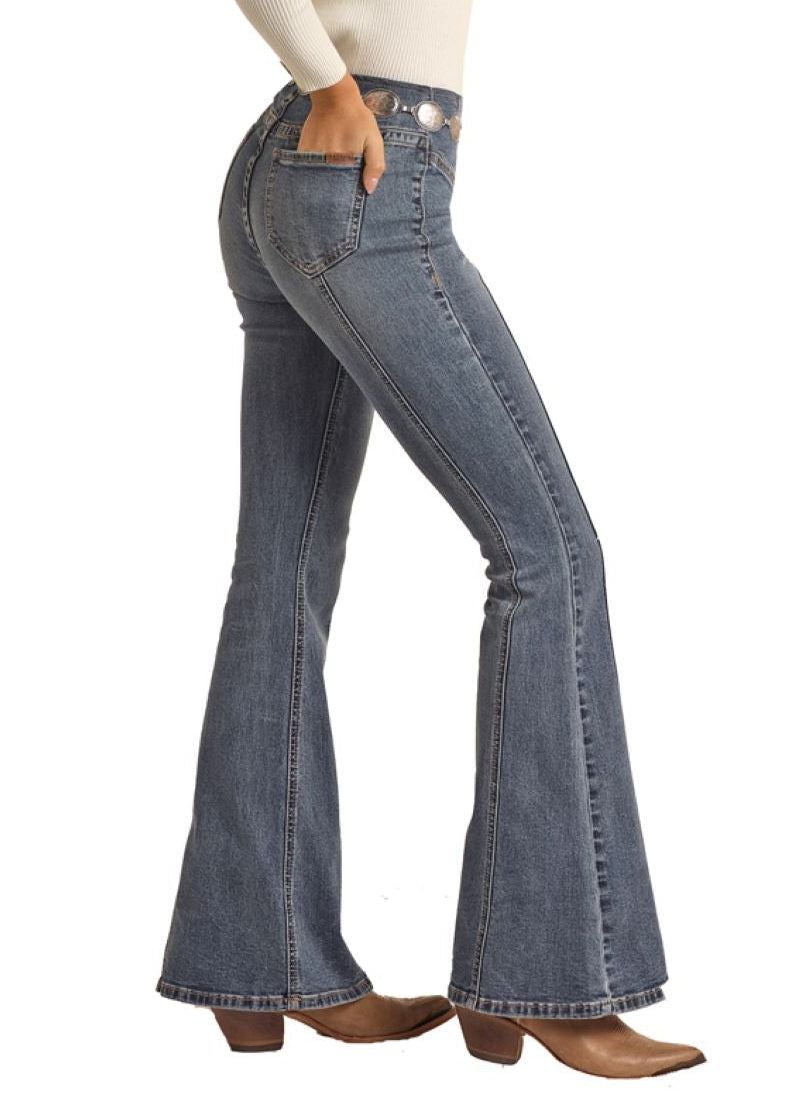 Woman wearing a white long-sleeve top, blue flared jeans, and a beige cowboy hat on a white background