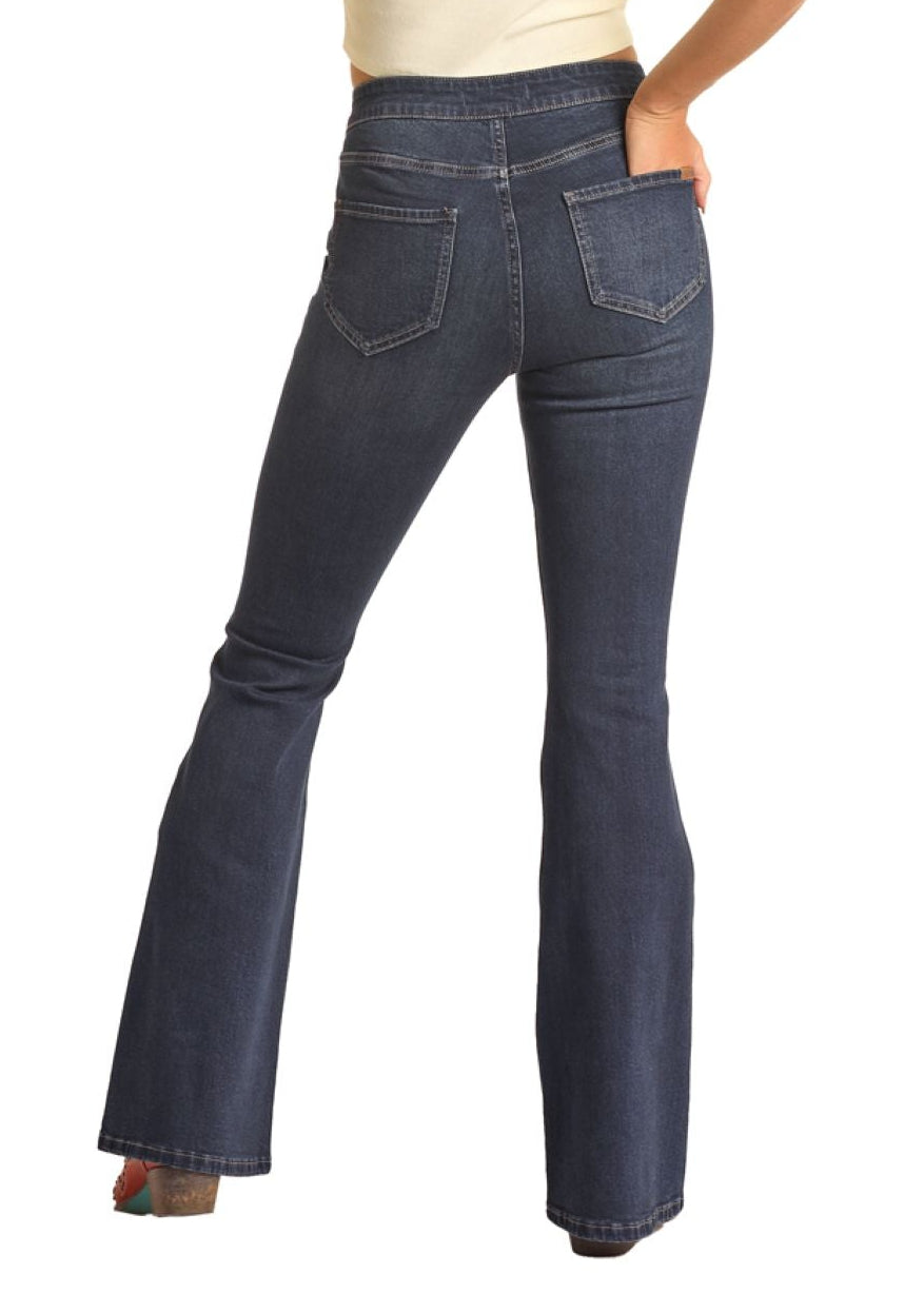 Woman wearing a white sleeveless top and blue jeans with a cowboy hat on a white background