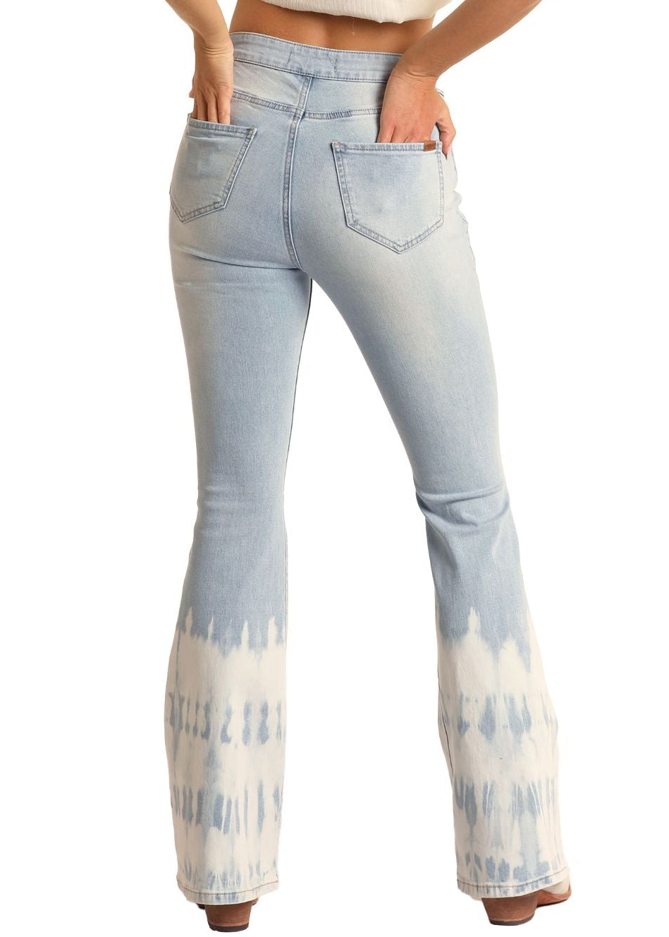 Woman wearing a white top and tie-dye jeans with a cowboy hat on a white background