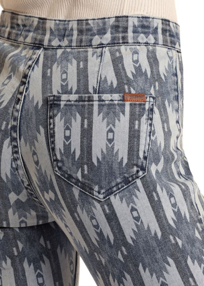 Patterned jeans with a visible brand logo on a white background